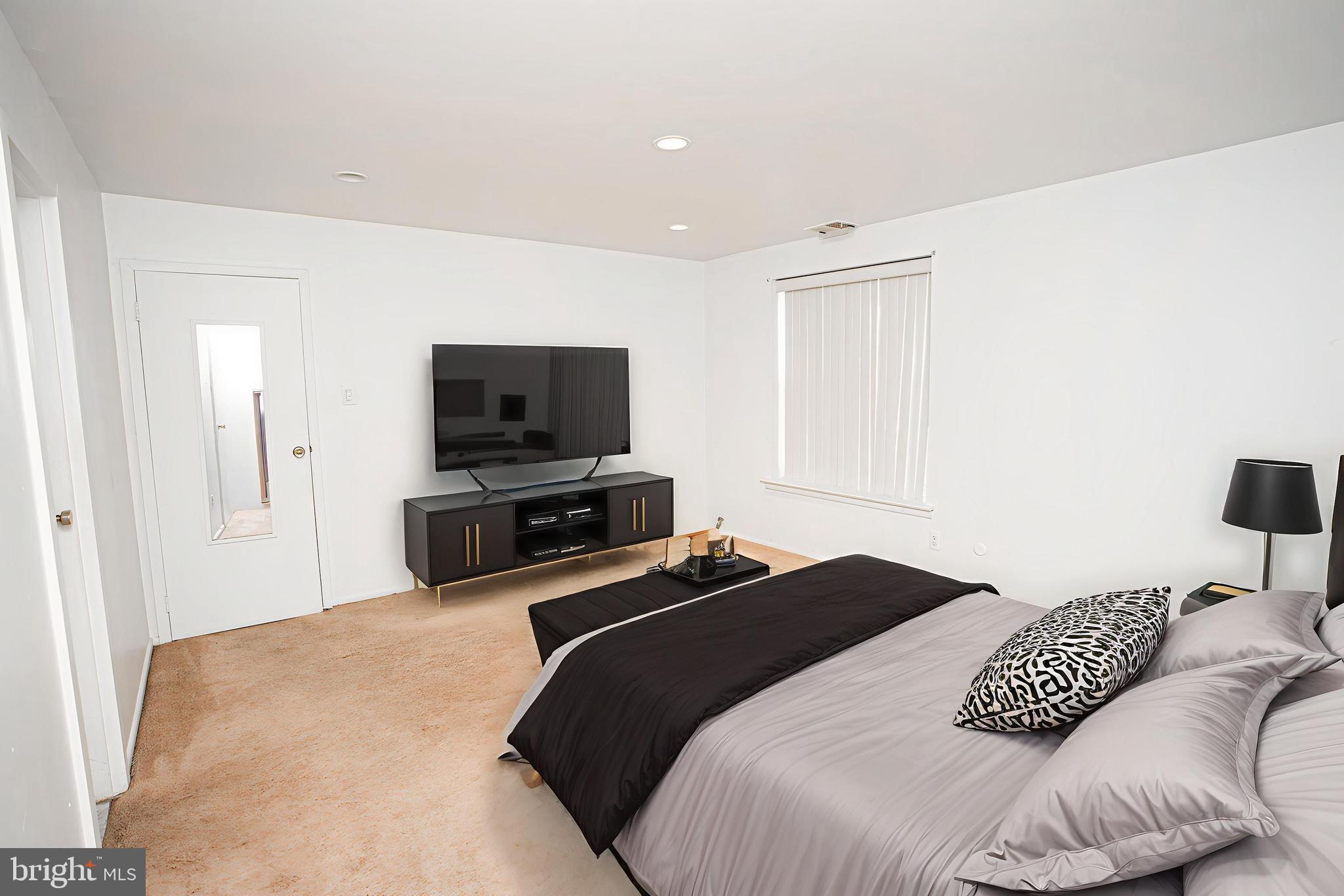 4000 Gypsy Lane, Unit 110C Philadelphia, PA 19129 - Photo 14 of 25 a bedroom with a bed and a flat screen tv
