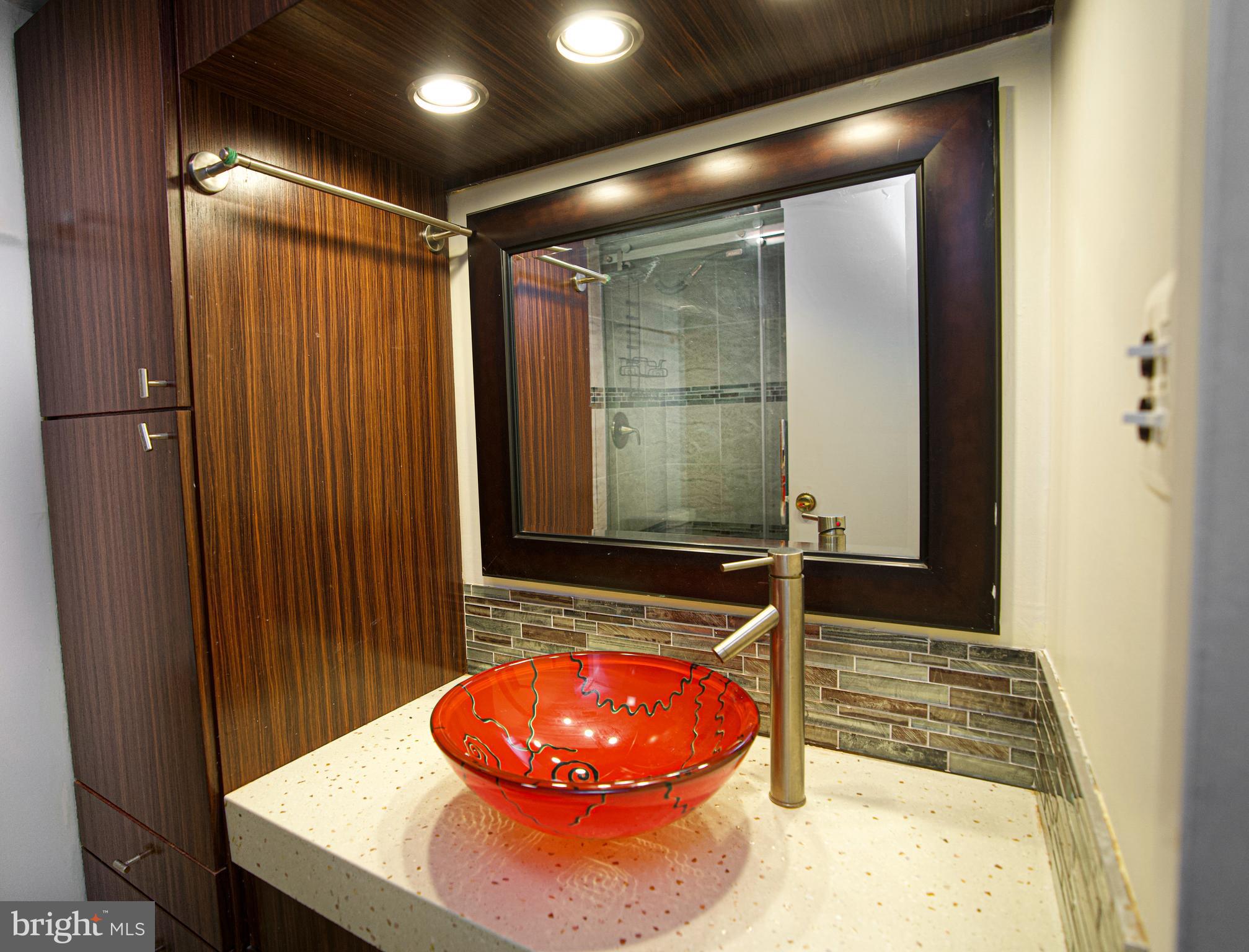 4000 Gypsy Lane, Unit 110C Philadelphia, PA 19129 - Photo 15 of 25 a bathroom with a sink and a mirror