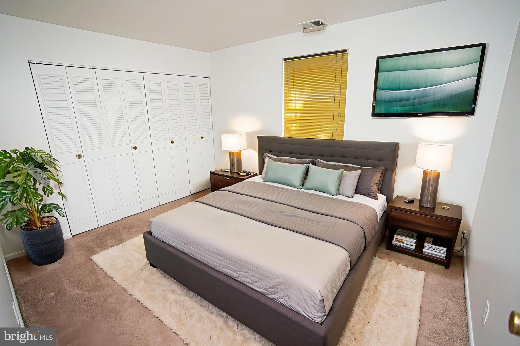 4000 Gypsy Lane, Unit 110C Philadelphia, PA 19129 - Photo 20 of 25 a bedroom with a bed and a flat screen tv