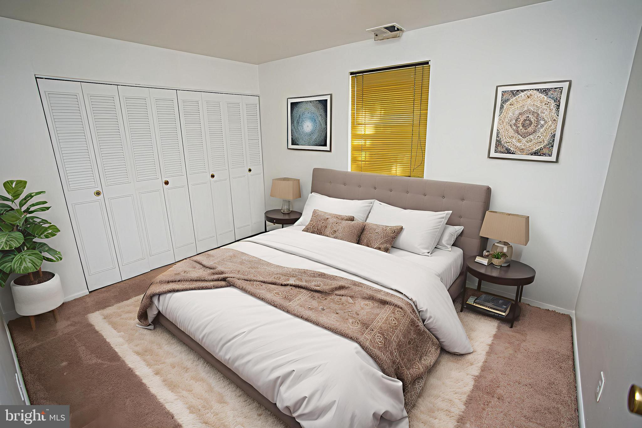 4000 Gypsy Lane, Unit 110C Philadelphia, PA 19129 - Photo 21 of 25 a bedroom with a bed and a potted plant