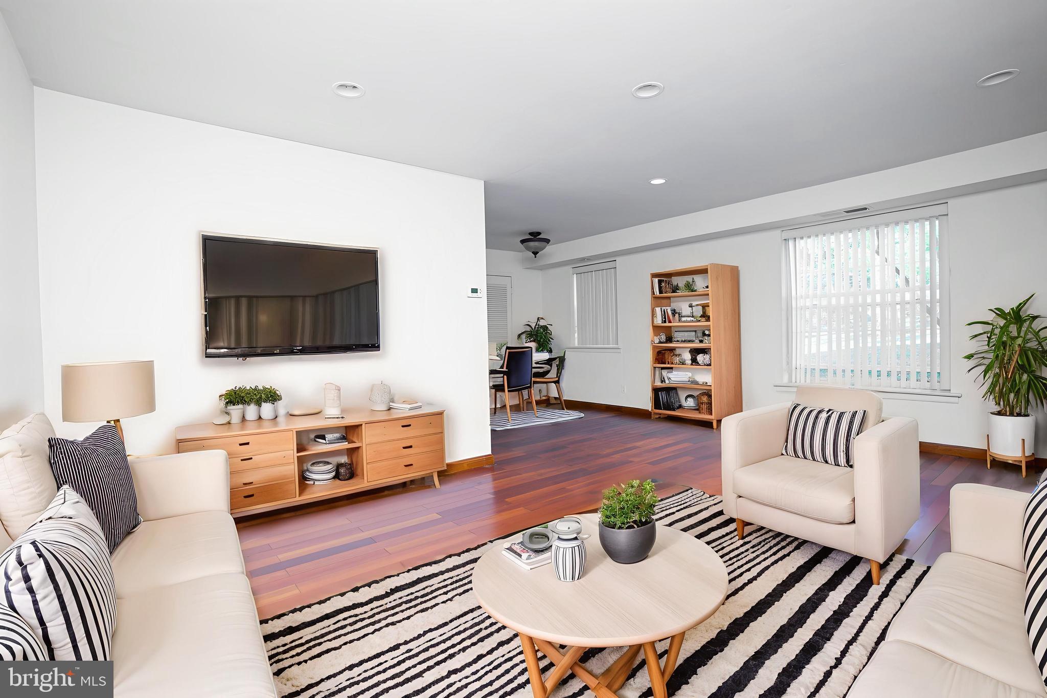 4000 Gypsy Lane, Unit 110C Philadelphia, PA 19129 - Photo 5 of 25 a living room with furniture and a flat screen tv