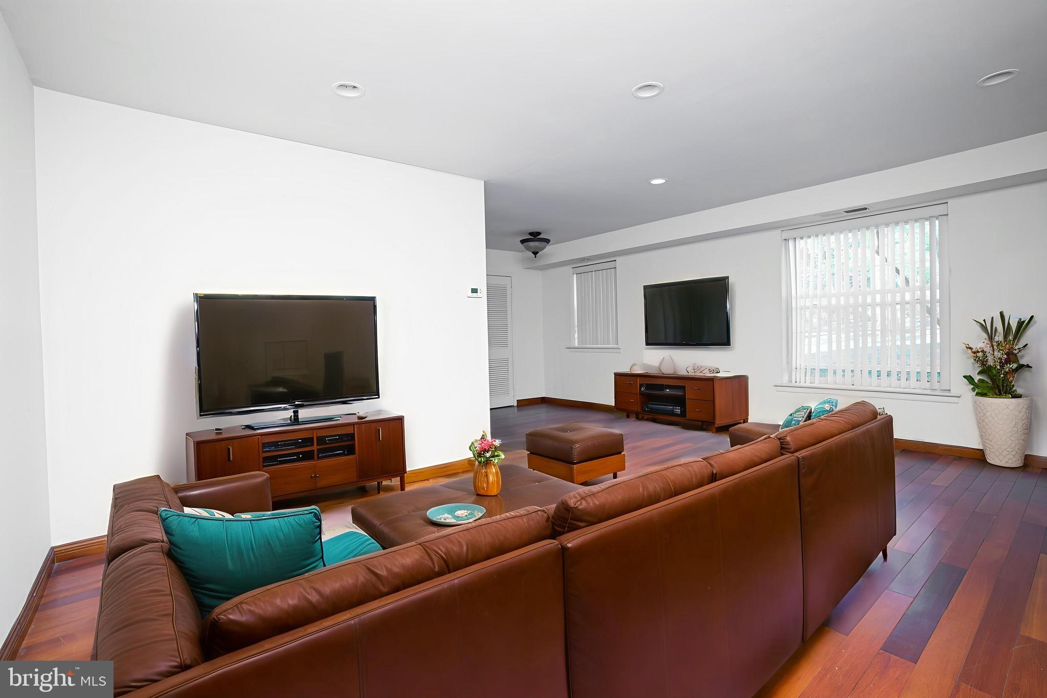 4000 Gypsy Lane, Unit 110C Philadelphia, PA 19129 - Photo 8 of 25 a living room with furniture and a flat screen tv