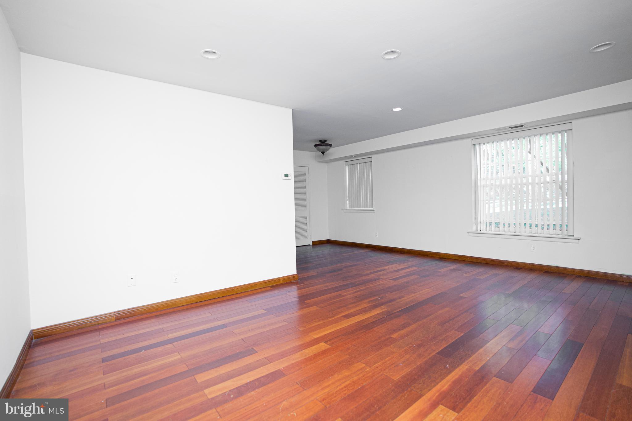 4000 Gypsy Lane, Unit 110C Philadelphia, PA 19129 - Photo 9 of 25 an empty room with wooden floor and windows