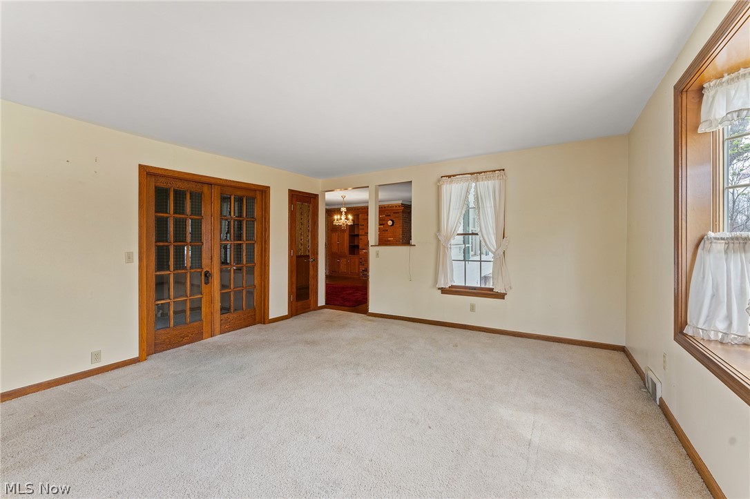 1815 Wick Campbell Road Hubbard, OH 44425 - Photo 22 of 43 Spare room featuring an inviting chandelier and light colored carpet
