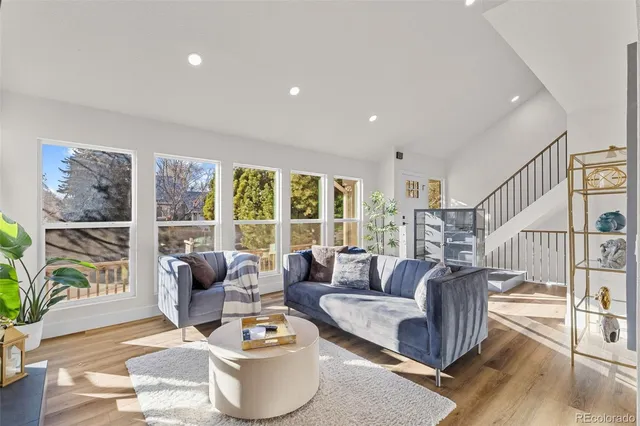 a living room with furniture and a floor to ceiling window