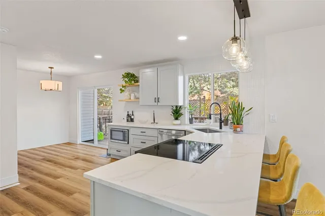 a kitchen with a sink appliances and cabinets