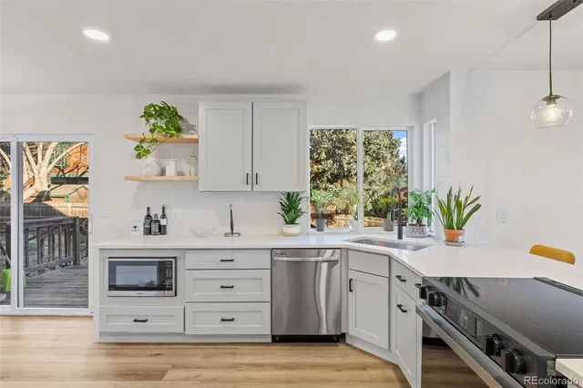 a kitchen with a white cabinets and window