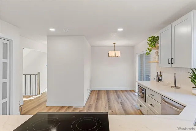 a kitchen with a sink and wooden floor