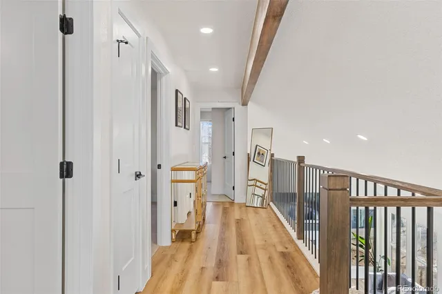 a view of a hallway with wooden floor
