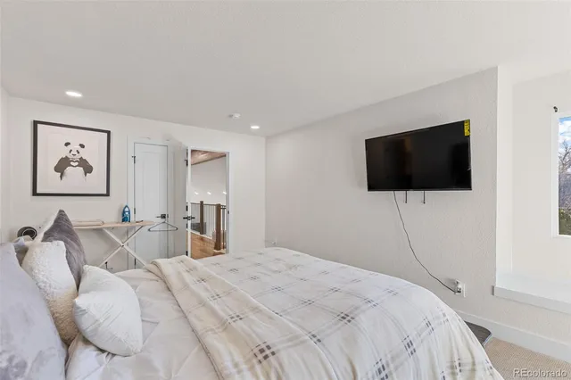 a bedroom with a bed and a flat screen tv