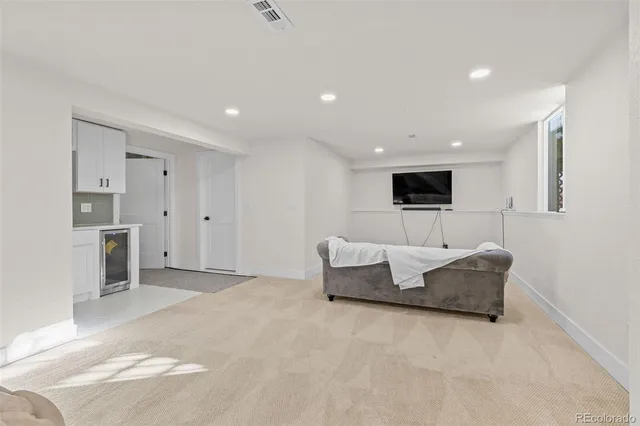 a living room with furniture and kitchen view