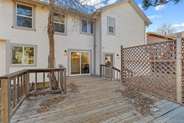 a view of backyard with deck and wooden floor