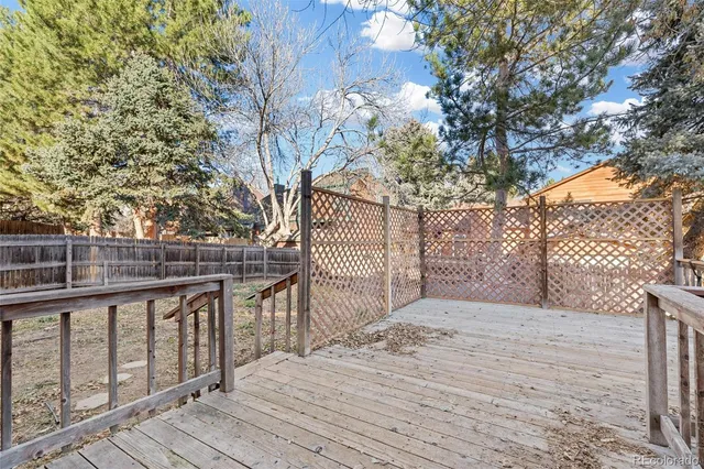 a view of a yard with wooden fence