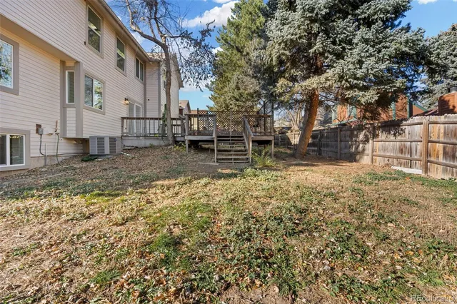a view of yard with wooden deck and seating space