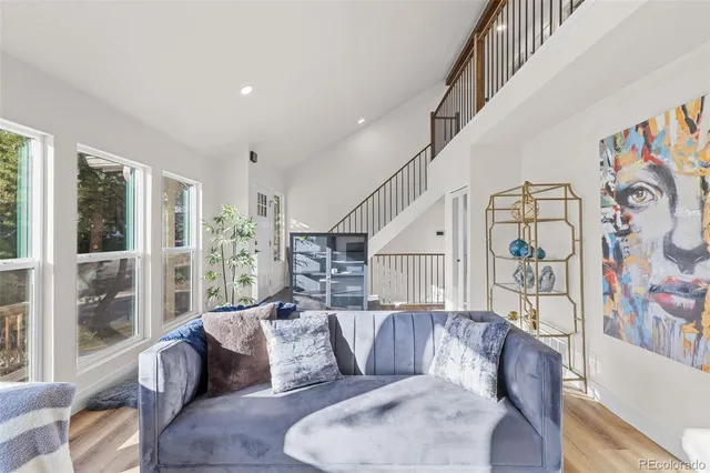 a living room with furniture and stairs