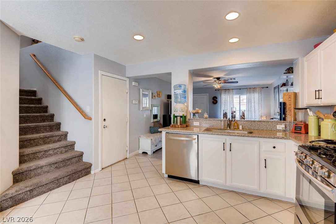 10451 Processor Court Las Vegas, NV 89129 - Photo 11 of 28 Seamlessly blending functionality and comfort, this kitchen provides a welcoming atmosphere for everyday living.