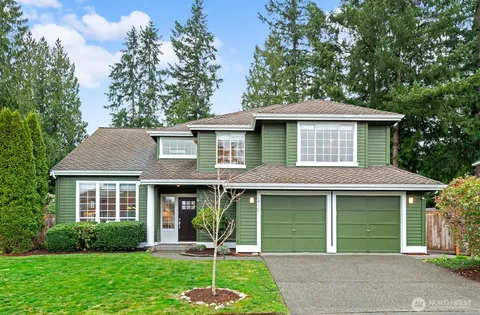 a front view of a house with a garden and plants
