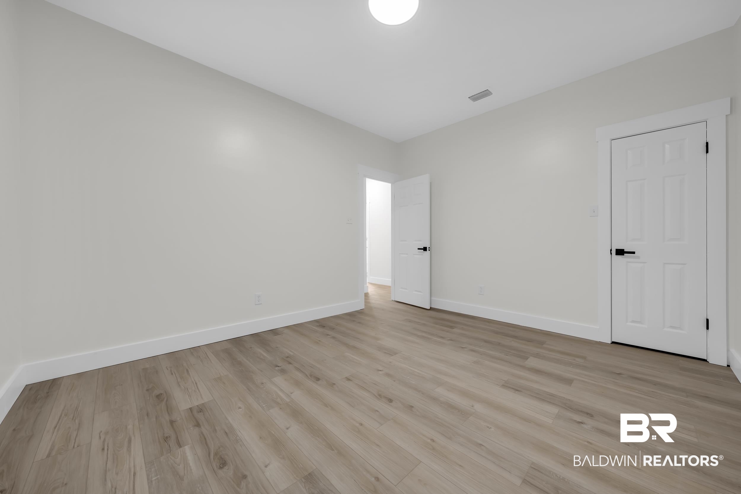 4924 Brooke Court Mobile, AL 36618 - Photo 27 of 34 Unfurnished bedroom featuring light wood-style floors and baseboards