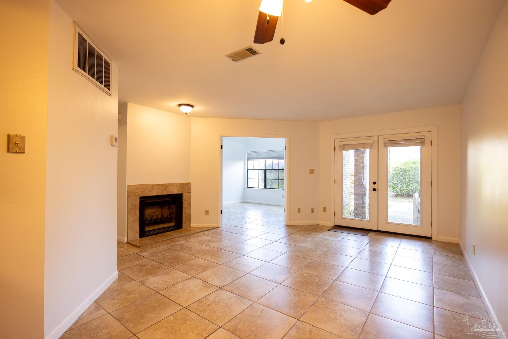 7150 Plantation Road, Unit 312 Pensacola, FL 32504 - Photo 1 of 14 a view of a livingroom with a fireplace and window