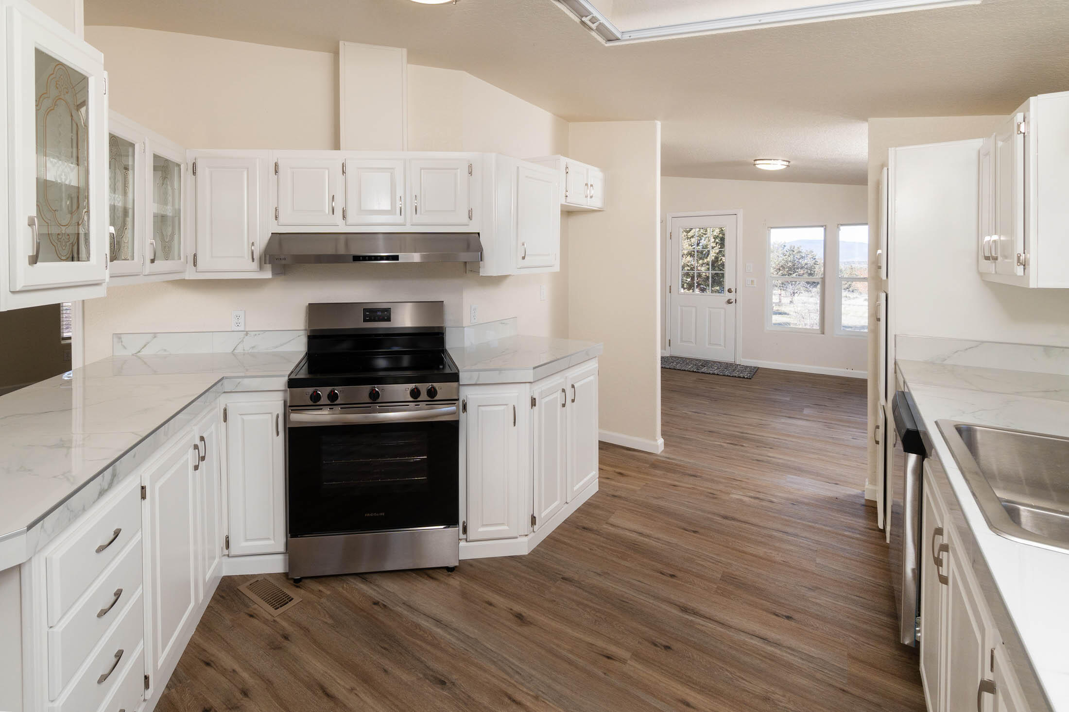 10113 Ridgeview Road Prineville, OR 97754 - Photo 9 of 31 a kitchen with stainless steel appliances a white stove top oven and cabinets