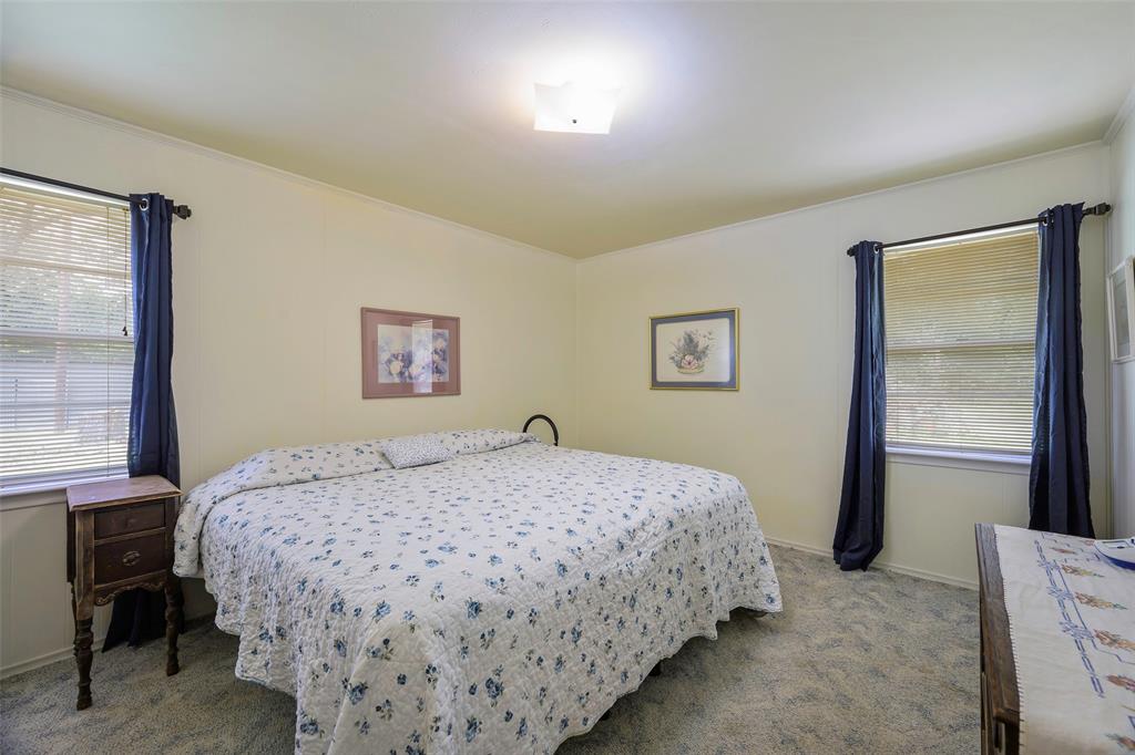 1113 West Will White Road Kemp, TX 75143 - Photo 14 of 22 a bedroom with a bed and a window