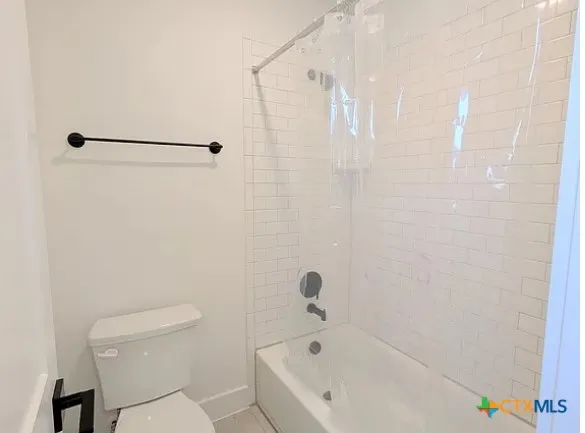 a bathroom with a bathtub and a toilet