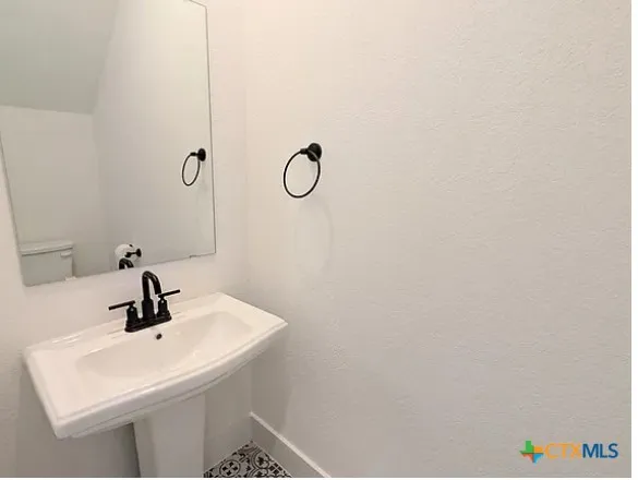 a bathroom with a sink a mirror and shower