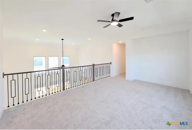 a view of a room with a ceiling fan