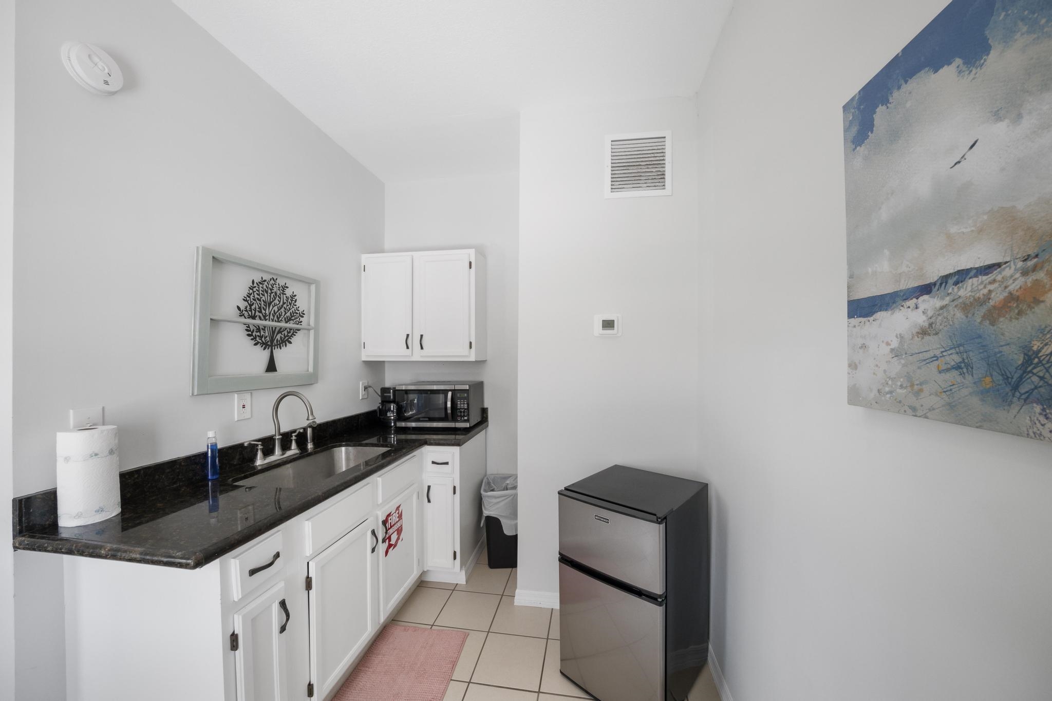 9 Menendez Road St. Augustine, FL 32080 - Photo 22 of 43 a kitchen with a sink and a refrigerator