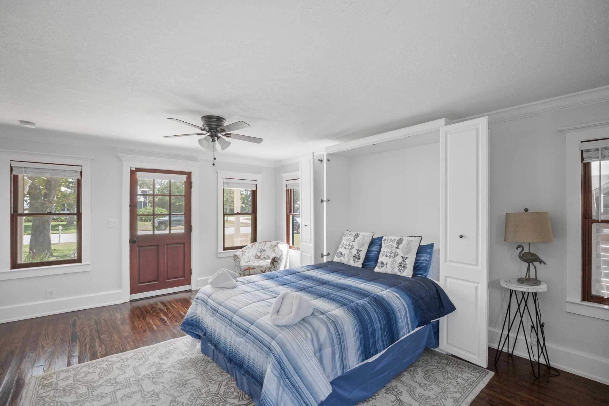 9 Menendez Road St. Augustine, FL 32080 - Photo 27 of 43 a bedroom with a large bed and a chandelier