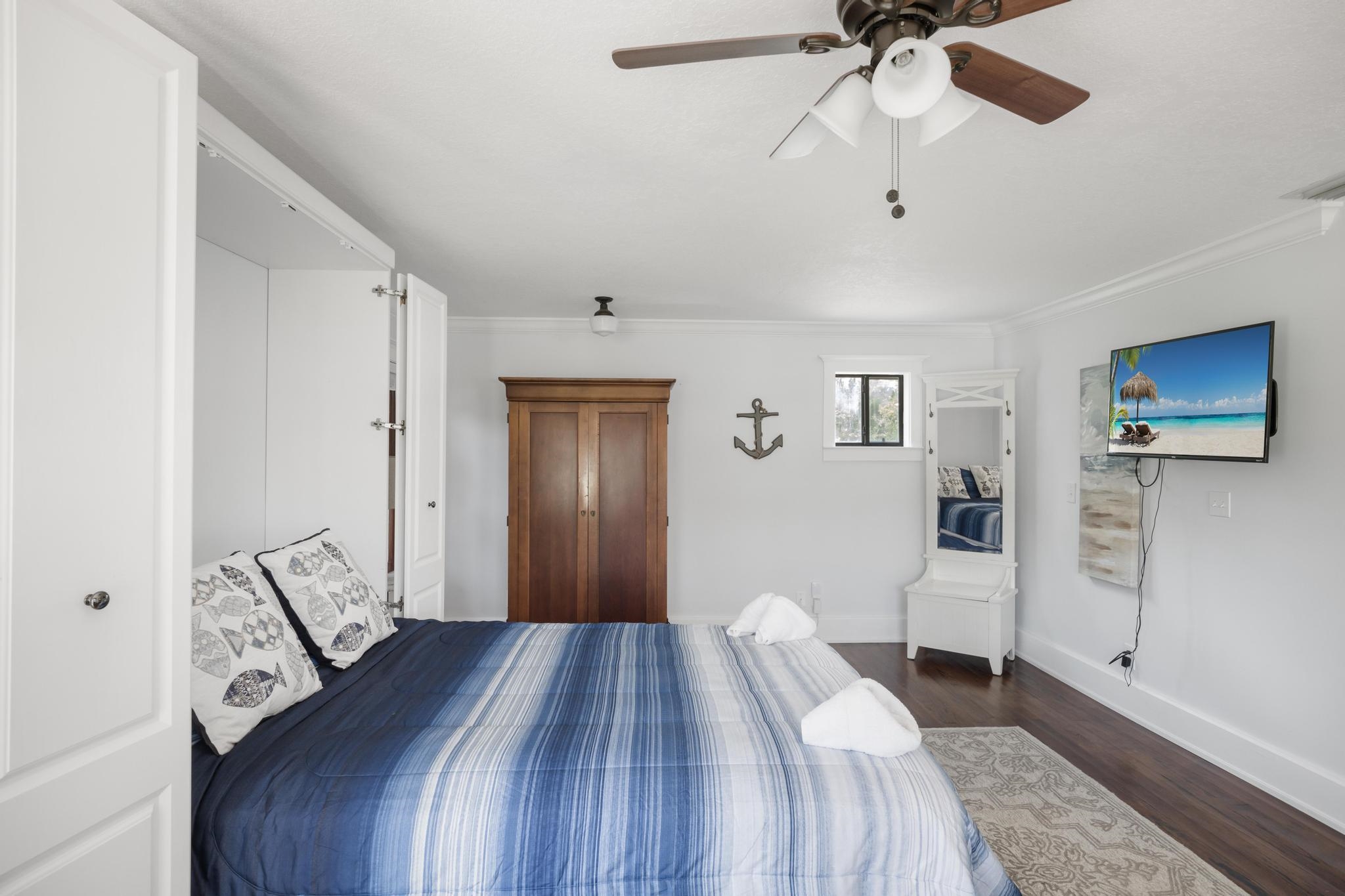 9 Menendez Road St. Augustine, FL 32080 - Photo 28 of 43 a bedroom with a bed and a chandelier