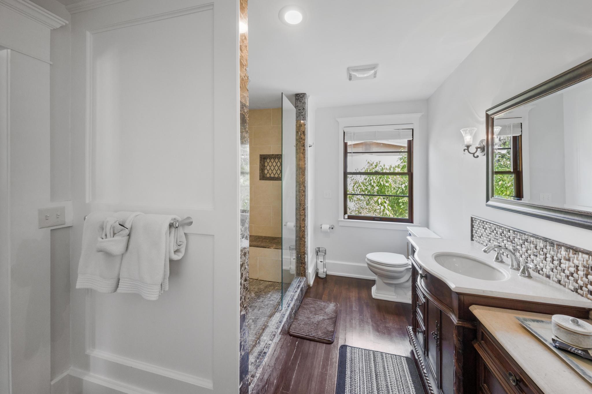 9 Menendez Road St. Augustine, FL 32080 - Photo 36 of 43 a spacious bathroom with a granite countertop double vanity sink a mirror and a shower