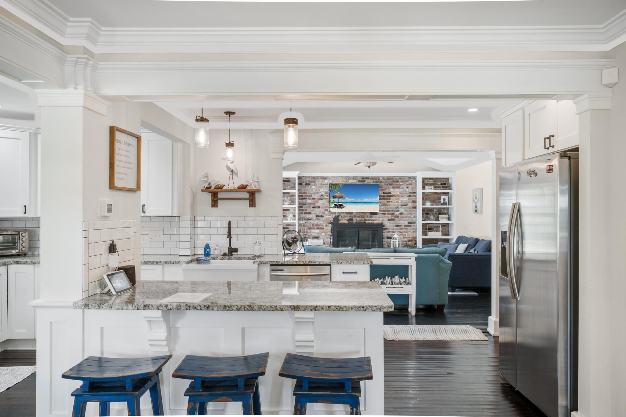 9 Menendez Road St. Augustine, FL 32080 - Photo 4 of 43 a kitchen with stainless steel appliances granite countertop a kitchen island and a refrigerator in it