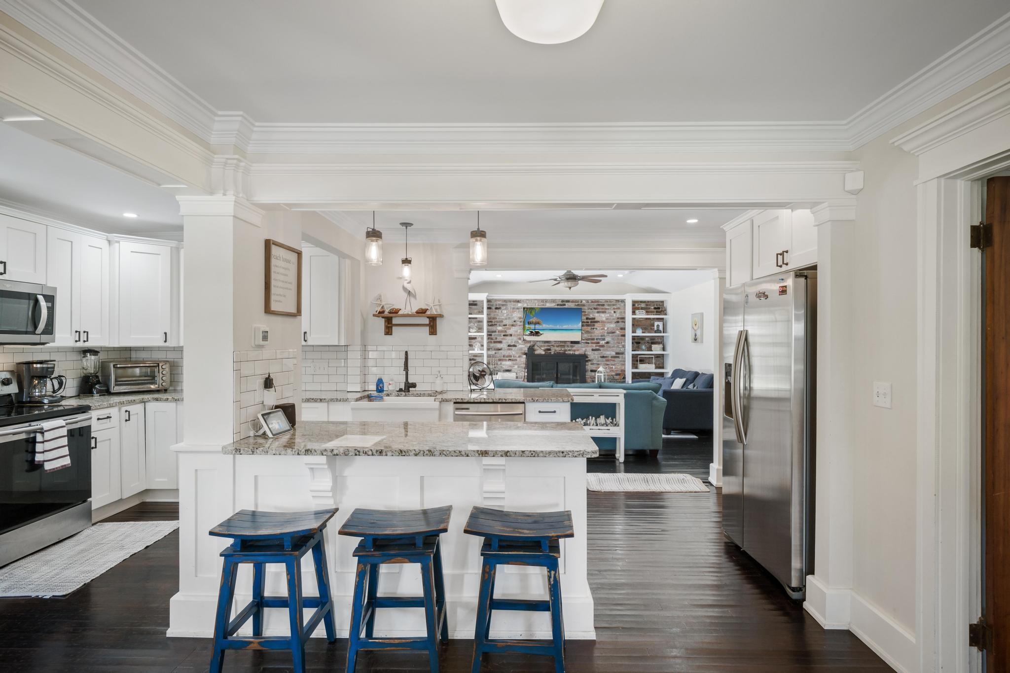 9 Menendez Road St. Augustine, FL 32080 - Photo 6 of 43 a large kitchen with kitchen island a refrigerator and a stove