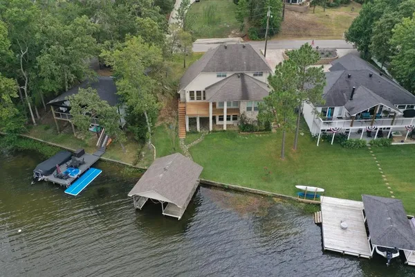 an aerial view of a house with swimming pool garden and patio