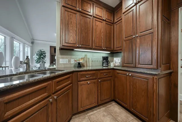 a kitchen with stainless steel appliances granite countertop wooden cabinets a sink and dishwasher