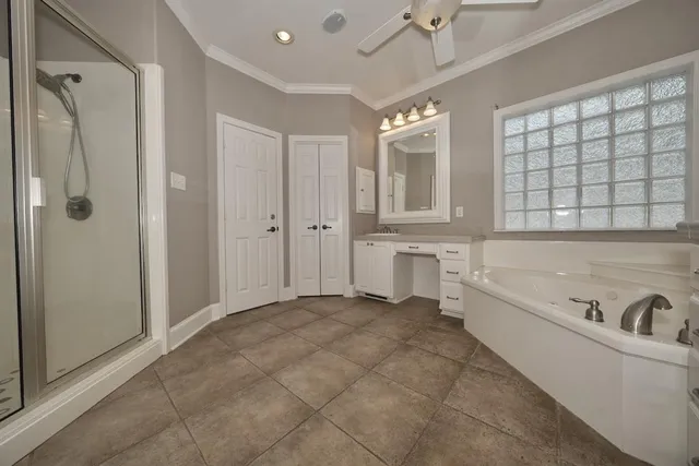 a spacious bathroom with a tub shower and sink