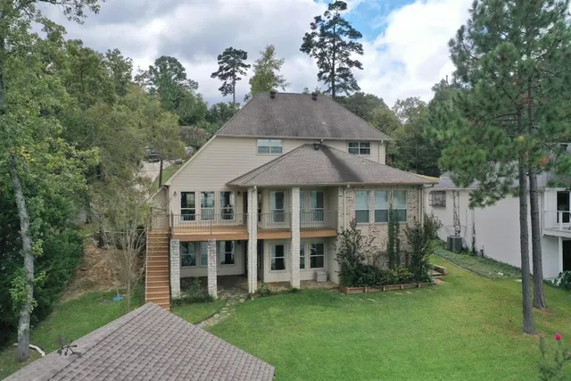 a view of a house with a yard and sitting area