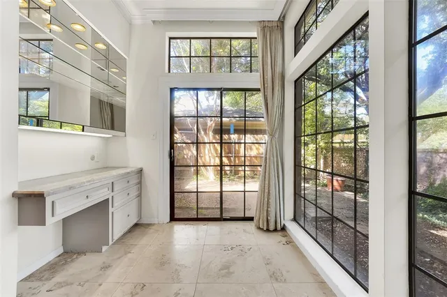 a view of a kitchen with entryway and windows