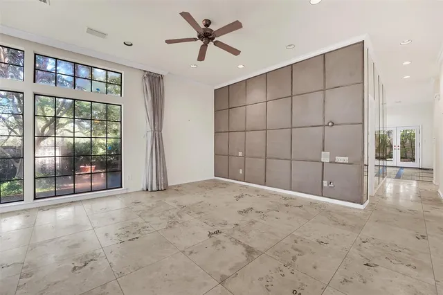 a view of a livingroom with a ceiling fan and window