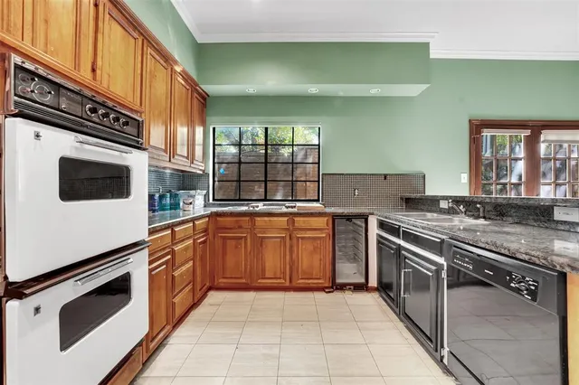 a kitchen with stainless steel appliances granite countertop a stove and a microwave