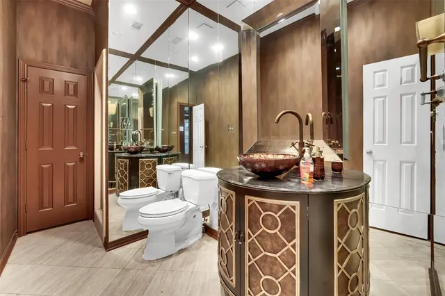 an empty room with a flat screen tv and windows