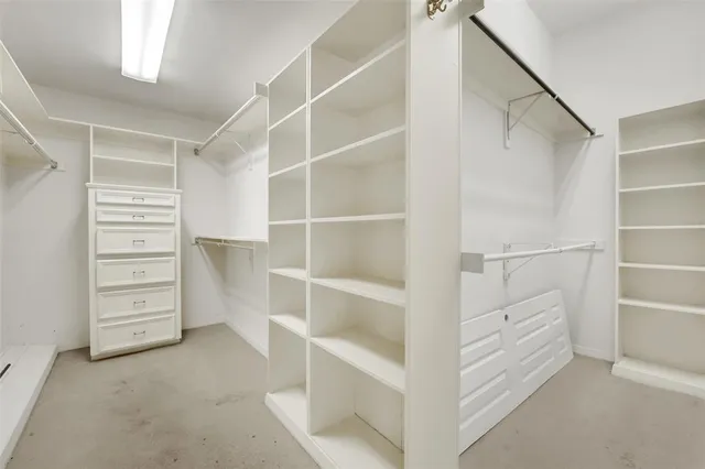 a view of closet area with wooden floor