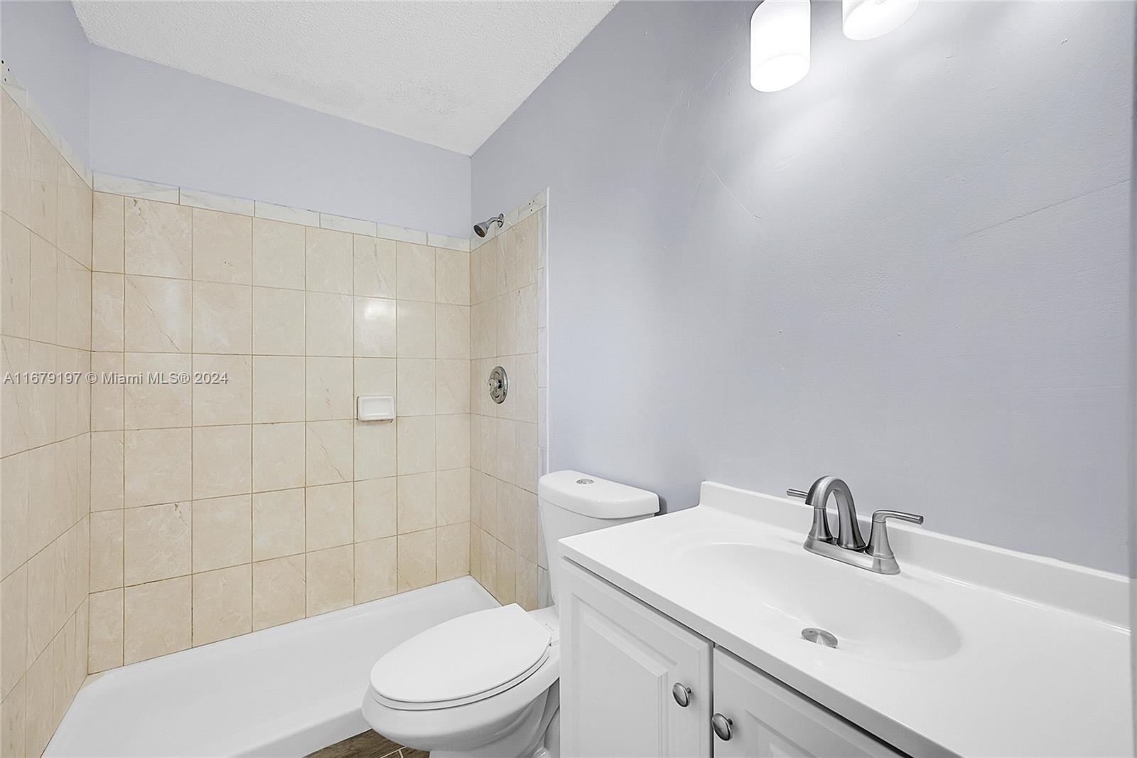 Greater Boynton Place Boynton Beach, FL 33437 - Photo 22 of 30 a bathroom with a sink a toilet and shower