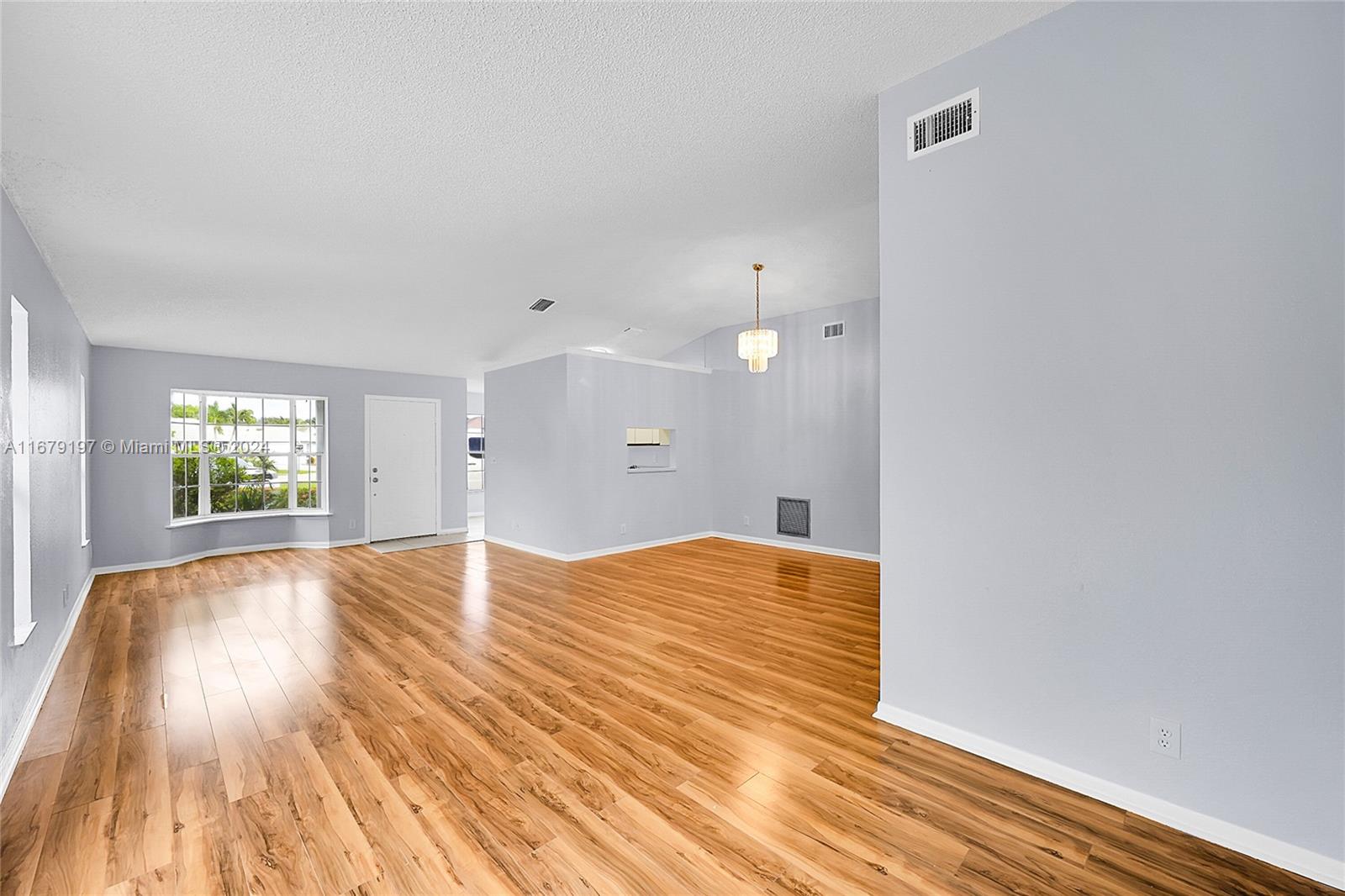 Greater Boynton Place Boynton Beach, FL 33437 - Photo 8 of 30 a view of empty room with wooden floor and fan