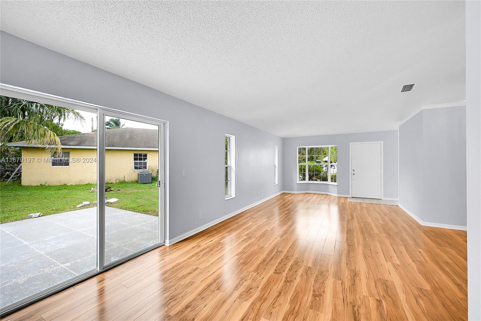 Greater Boynton Place Boynton Beach, FL 33437 - Photo 9 of 30 a view of an empty room with wooden floor and a window