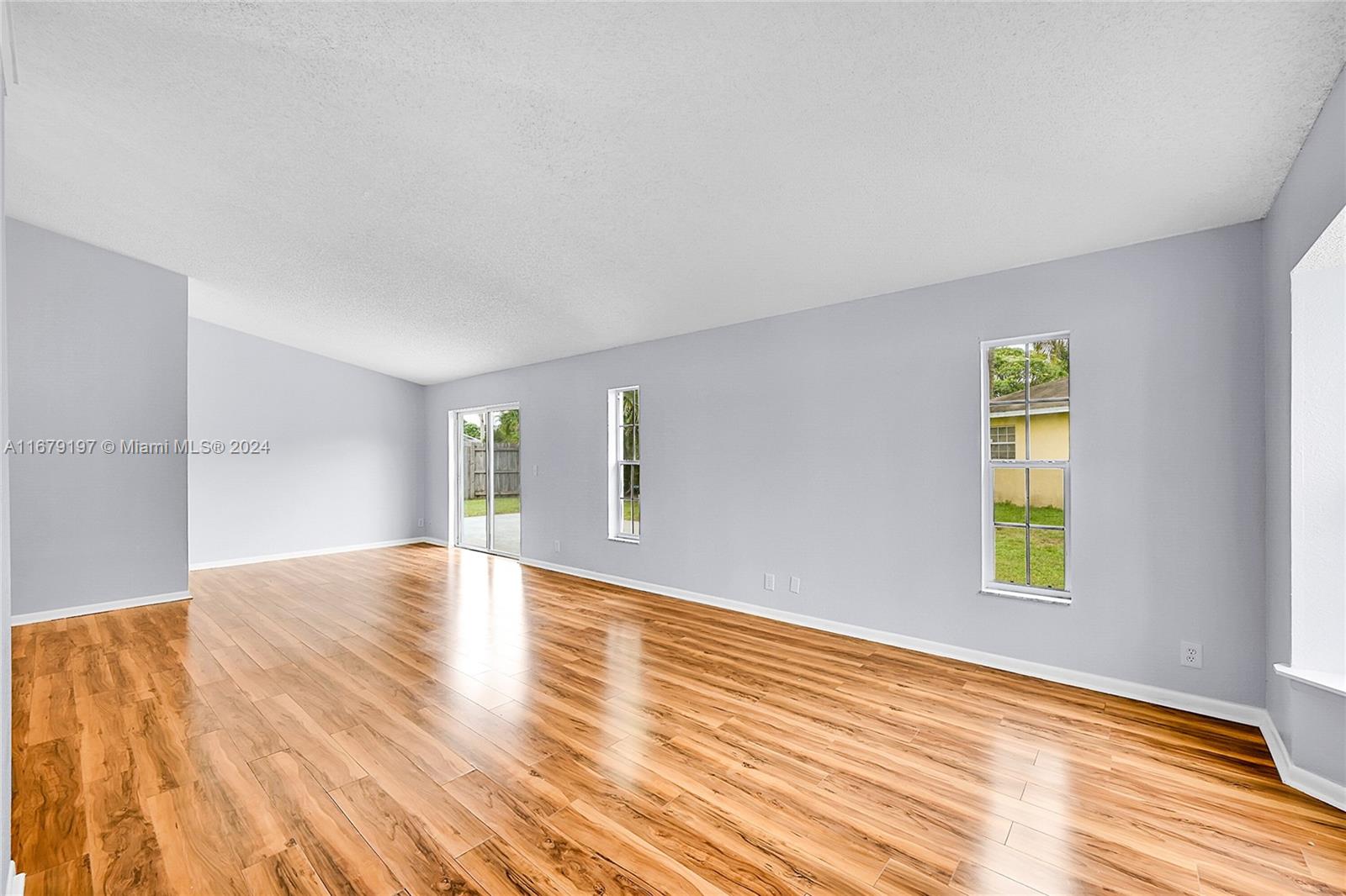 Greater Boynton Place Boynton Beach, FL 33437 - Photo 10 of 30 a view of empty room with wooden floor and fan