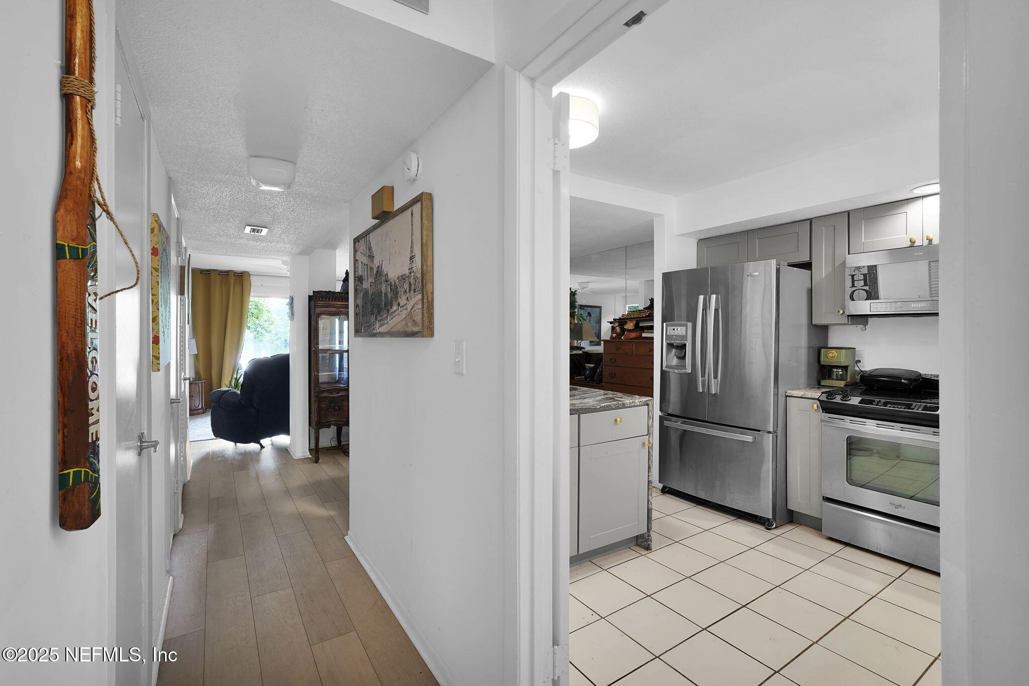 9901 Regency Square Boulevard, Unit 90 Jacksonville, FL 32225 - Photo 11 of 27 a kitchen with a refrigerator and a sink