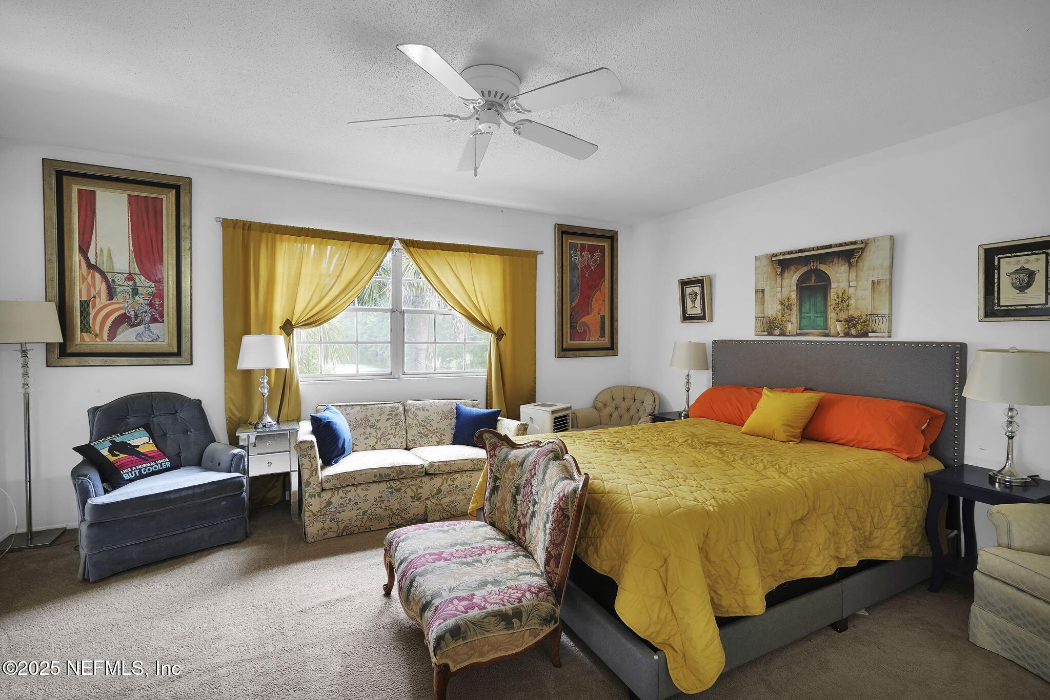 9901 Regency Square Boulevard, Unit 90 Jacksonville, FL 32225 - Photo 13 of 27 a bedroom with a bed couch and window