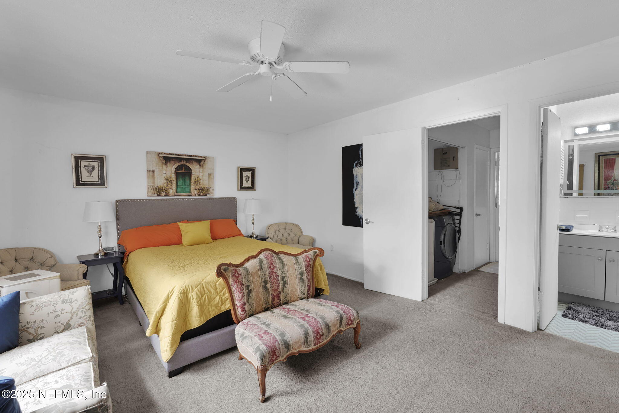 9901 Regency Square Boulevard, Unit 90 Jacksonville, FL 32225 - Photo 14 of 27 a spacious bedroom with a bed and a chandelier